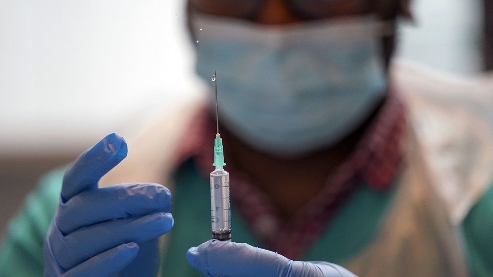 A image of a medical professional holding a syringe