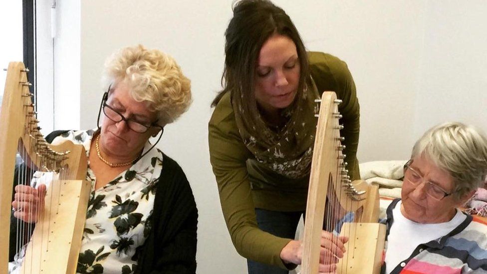 Katy Bustard teaching two of her harp students