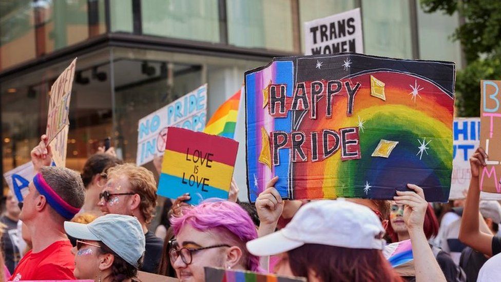 People with placards celebrating pride in Bristol