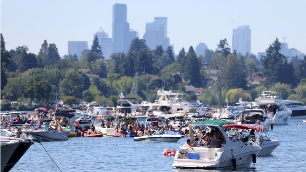 People in boats party on Lake Washington during a heat wave in Seattle