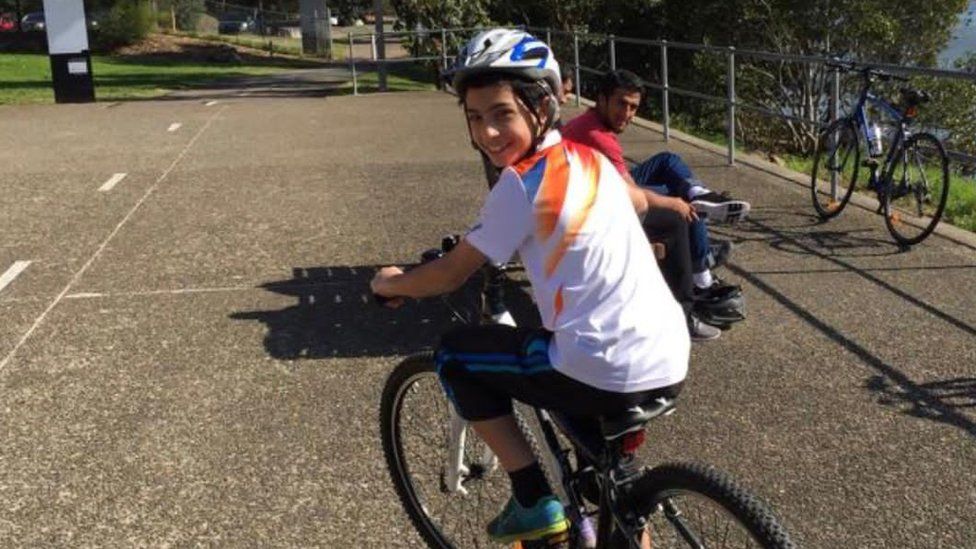 Yusuf Zahab rides a bike in Australia