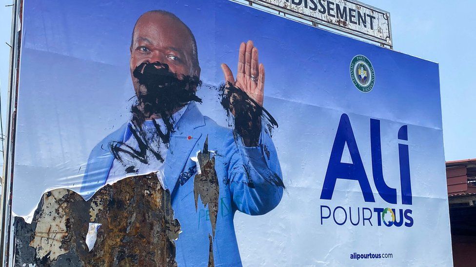 A general view of a defaced campaign billboard of ousted Gabon President Ali Bongo Ondimba in Libreville on August 31, 2023.