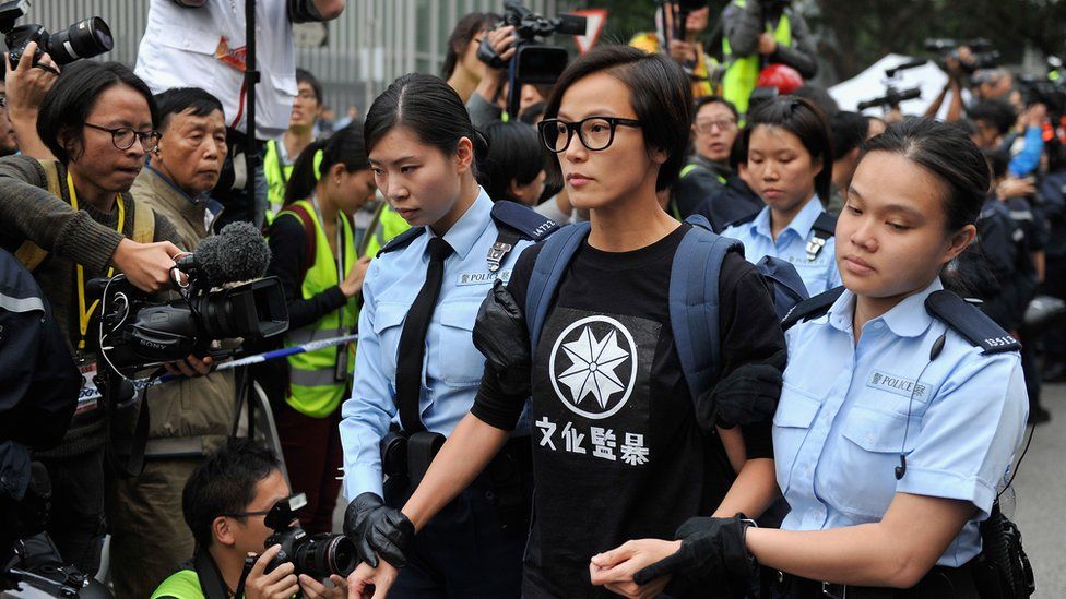 Singer Denise Ho is being arrested and escorted by police officers during the clearance of Occupy Central Pro-democracy camp in Admiralty