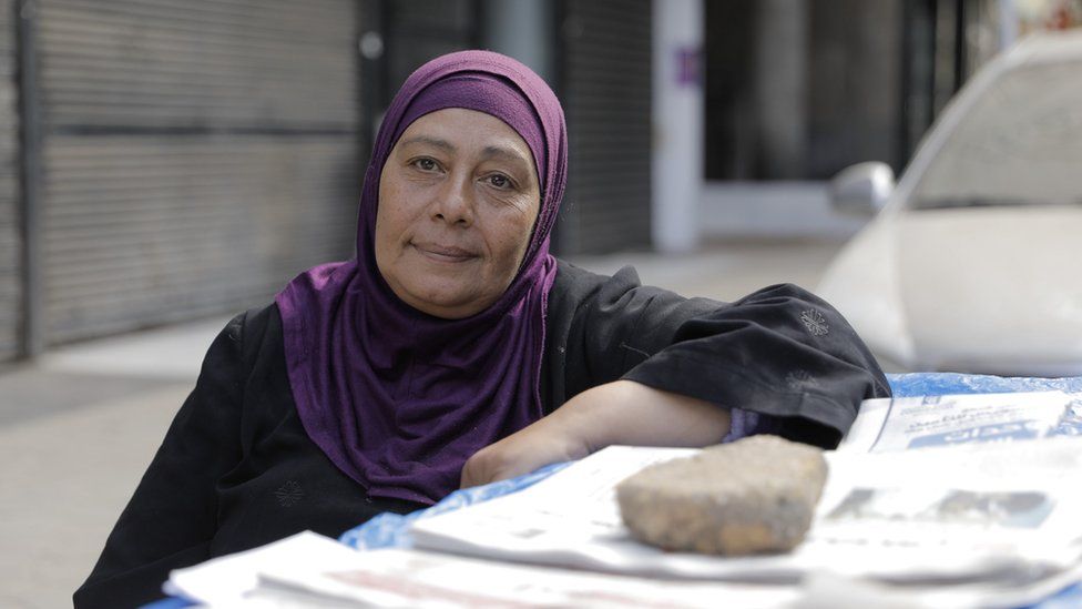 Nadia, a widow and a mother of six has been selling newspapers in Cairo