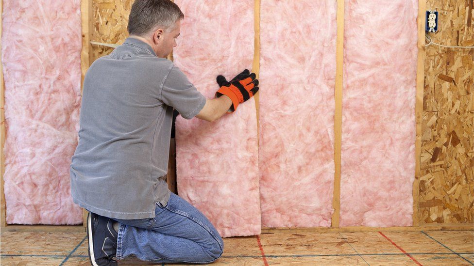 Man putting in home insulation