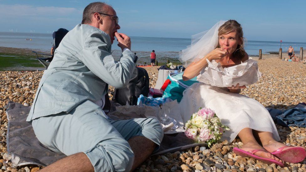 Newlyweds pictured on a beach