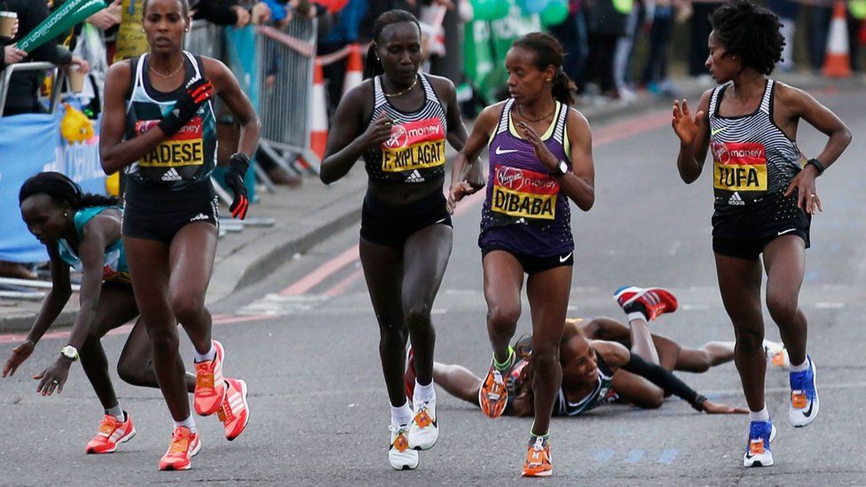 Runners fall after a water station