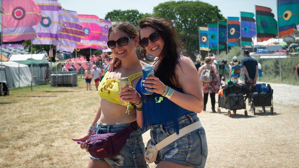 Two women enjoying the sunshine at the Isle of Wight Festival