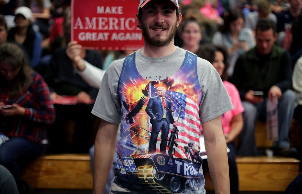 A man wears a tank top depicting Republican presidential nominee Donald Trump standing on a tank during a campaign rally for Trump at the W.L. Zorn Arena November 1, 2016 in Eau Claire, Wisconsin.