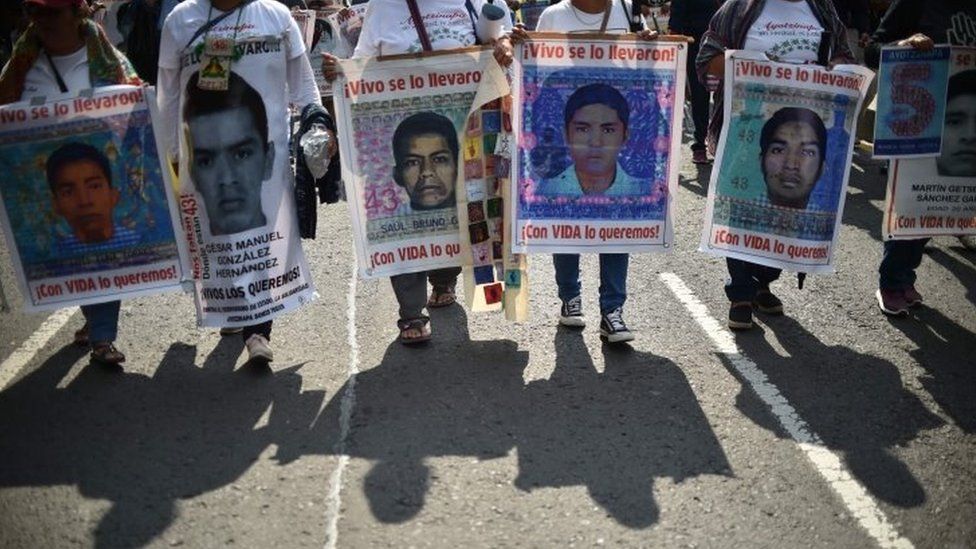 In this file photo taken on 26 September 2019 people protest in Mexico City to mark five years of the disappearance of the 43 students of the teaching training school in Ayotzinapa