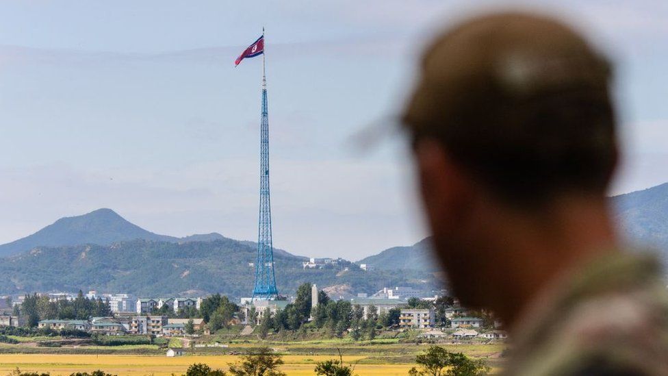 A United Nations Command (UNC) soldier looks at a view of North Korea from inside the demilitarized zone (DMZ)