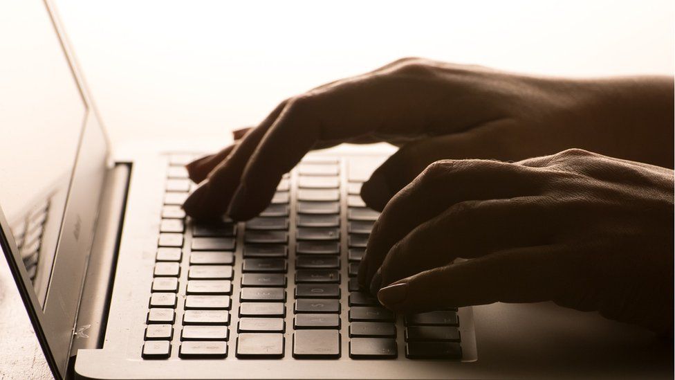 File photo of someone typing on a laptop keyboard