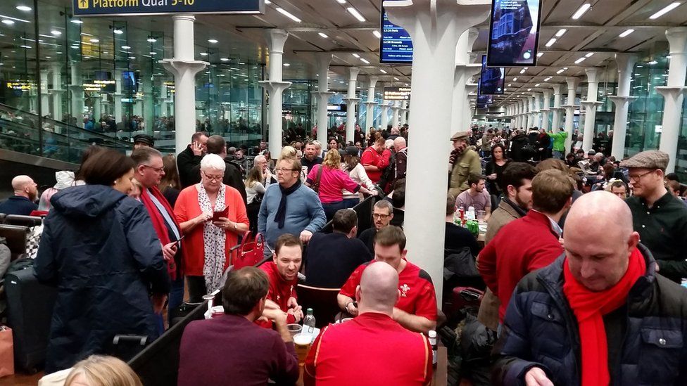 Wales fans wait at the Eurostar terminal at St Pancras, London