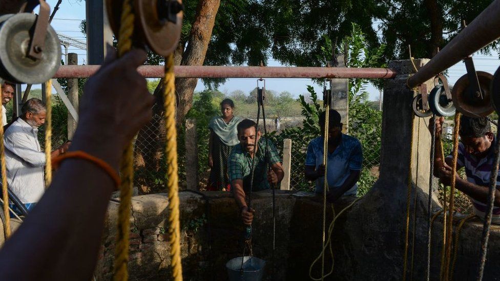 In this photo taken on June 20, 2019, Indian residents collect water from a community well in Chennai after reservoirs for the city ran dry.