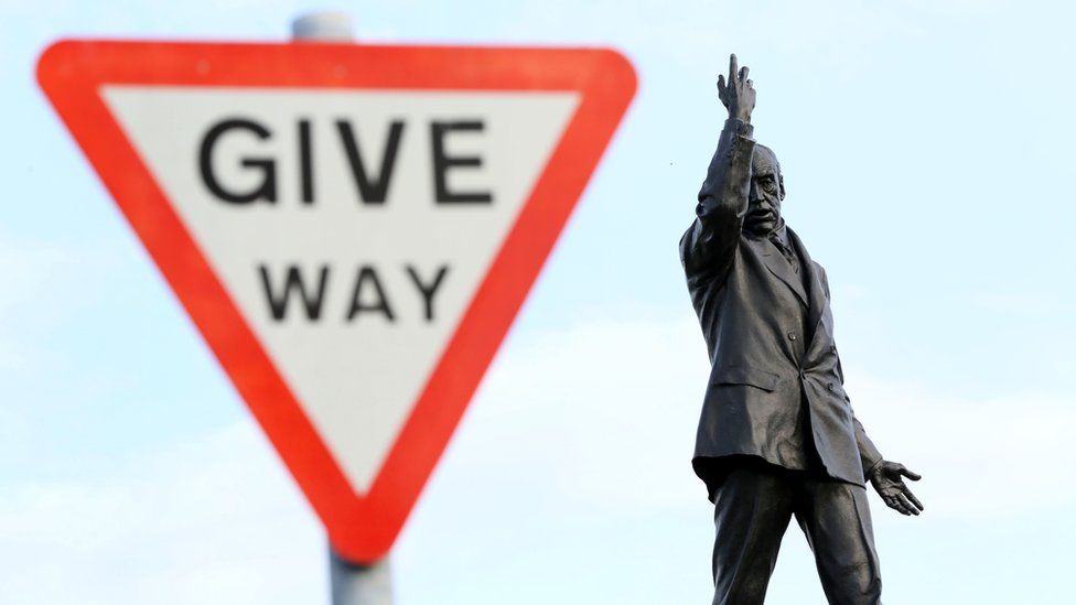 A 'Give way' sign next to the statue of former unionist leader Lord Carson at Stormont