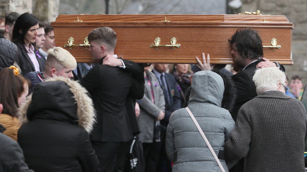 Morgan Barnard's coffin is carried into the church