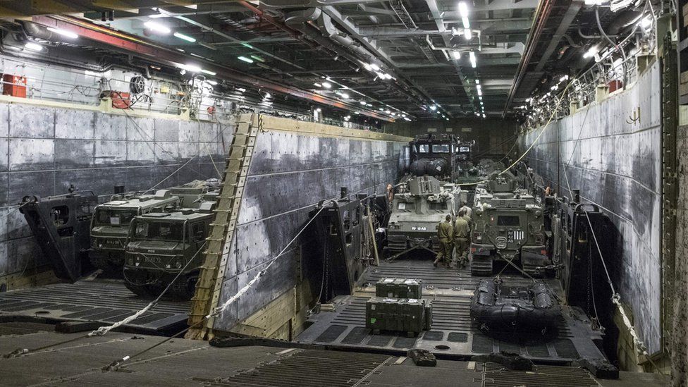 Armoured vehicles and trucks aboard HMS Bulwark as it docks at the port in the Israeli coastal city of Haifa
