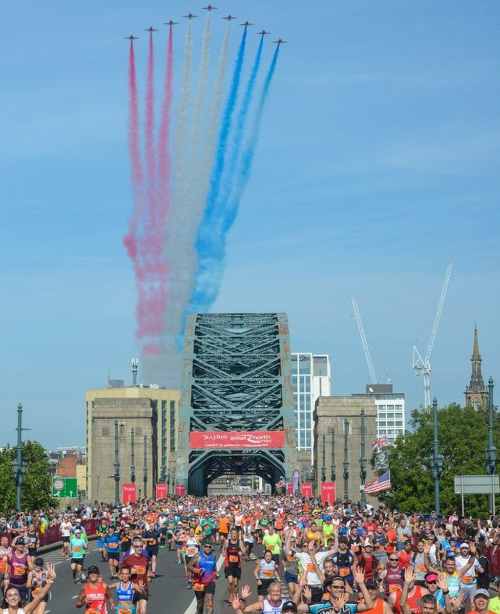 Great North Run runners with Tyne Bridge and the Red Arrows in the background