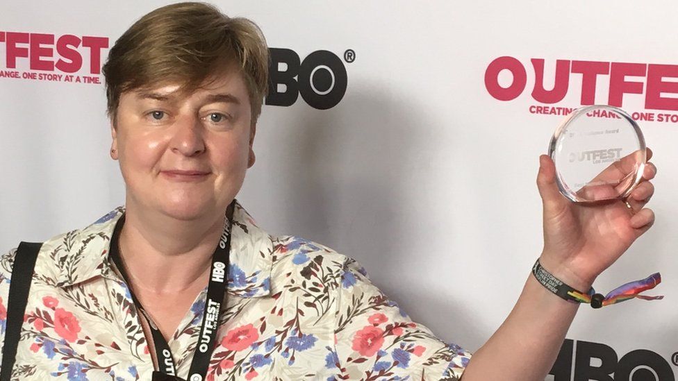 Rachel Dax with her award at Outfest