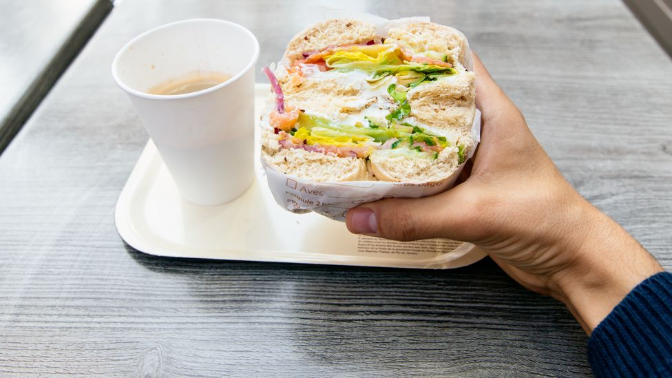 Man with sandwich and coffee