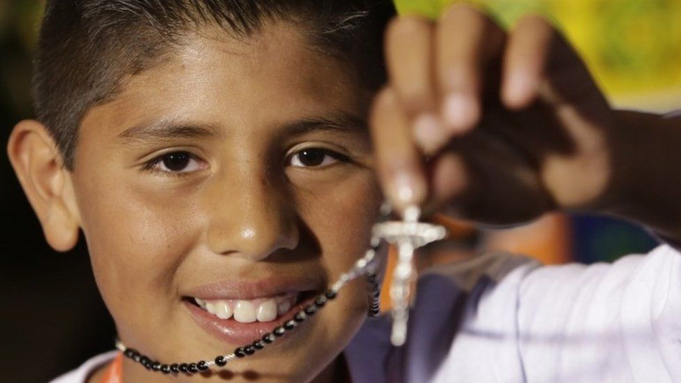 Brayan Fernandez, one of the children from the District's Institute for the Protection of Childhood and Youth, shows a rosary he was given by Pope Francis at the Papal Nunciature in Bogotá, Colombia, 6 September