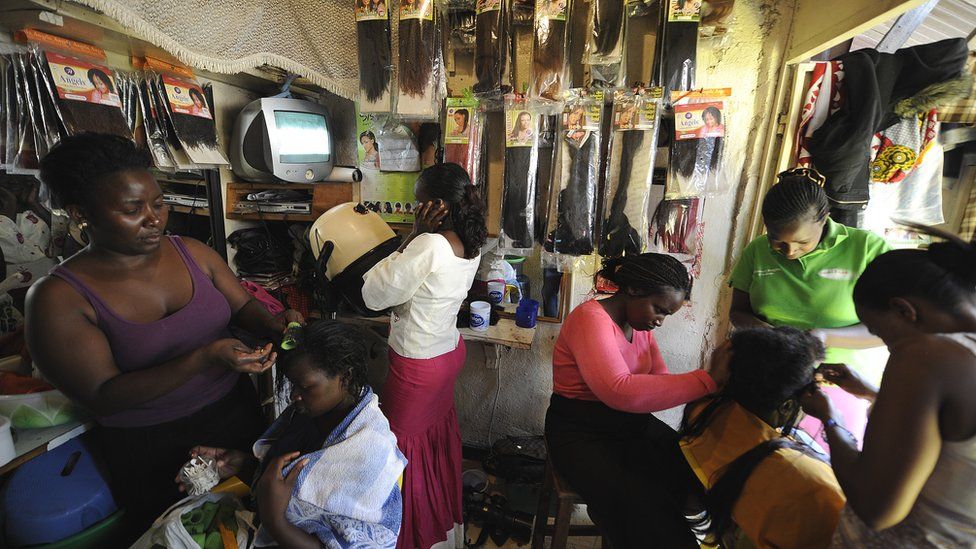 Kenyan hairdressers attending to clients at a salon in the capital Nairobi - archive shot