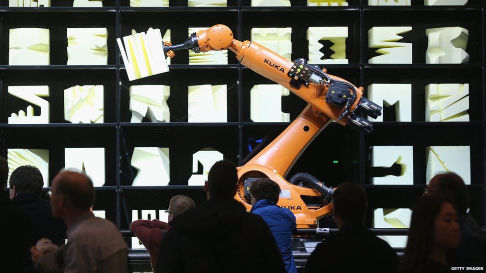 A Kuka robot performs as part of the Robochop interactive robot installation at the 2015 CeBIT technology trade fair