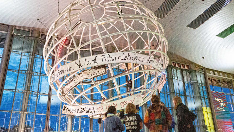 Activists occupy the globe in the lobby of the Volkswagen Autostadt in Wolfsburg, Germany, 13 August 2019
