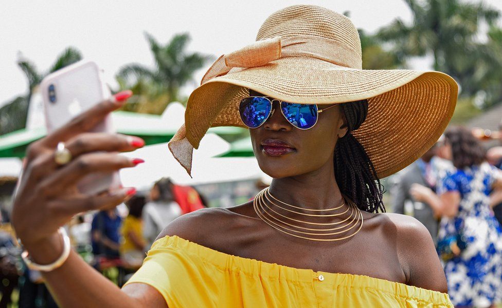 A woman taking a selfie at the Royal Ascot Goat Races in Kampala, Uganda - Saturday 25 August 2018