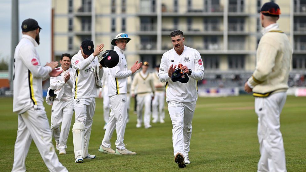 Marchant de Lange of Gloucestershire is applauded off the pitch at the County Ground in Bristol