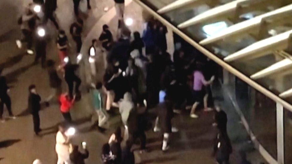 Crowd kicks and hits windows of Paris Nike store