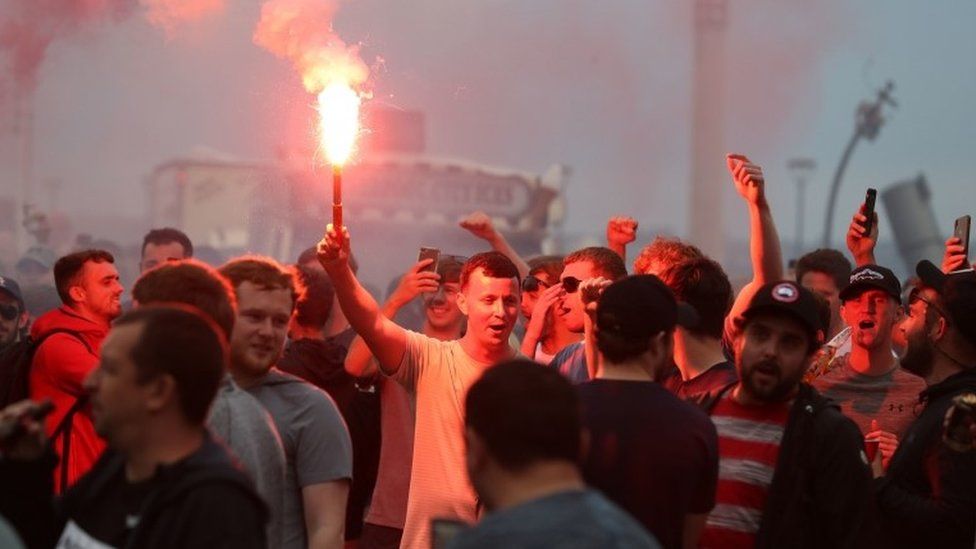 Liverpool fans let off flares outside the Liver Building in Liverpool. PA Photo. Picture date: Friday June 26, 2020