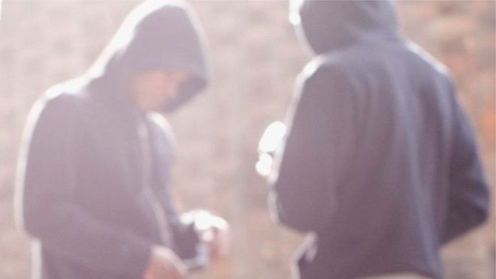 Anonymous youths in hoods