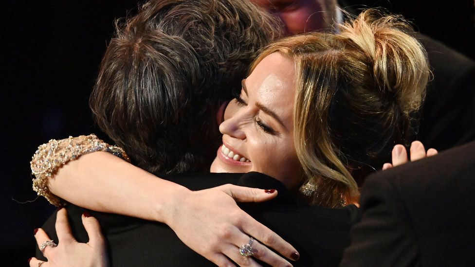 Cillian Murphy and Emily Blunt embracing at the Baftas