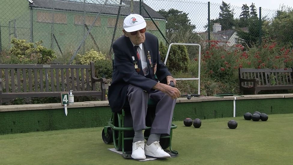 Mr Short bowling from his chair