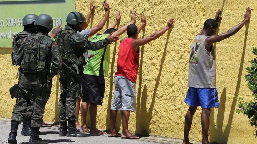Army soldiers check people, during a military police strike over wages, while patrolling the streets of Vila Velha, Espirito Santo, Brazil, February 11, 2017