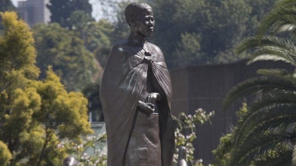 Officials gather around a statue of a spirit medium known as Mbuya Nehanda (C) soon after it"s unveiling by Zimbabwean President Emmerson Mnangagwa during the Africa Day celebrations in Harare, Zimbabwe, 25 May 2021. Zimbabwe has joined many other African countries in commemorating Africa Day, that marks the creation of the Organisation of African Unity on 25 May 1963