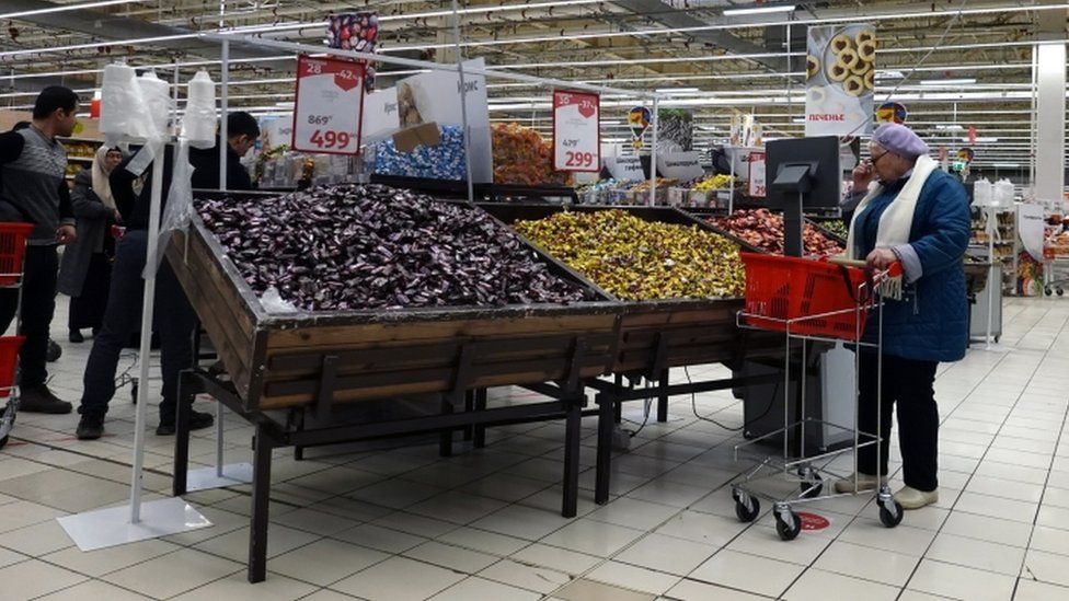 people shopping at a store of French supermarket chain Auchan in Moscow