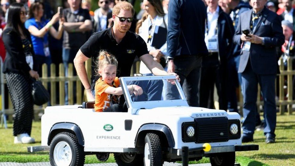 Prince Harry was driven in a miniature car by four-year-old Dutch girl Scarlet Vroegop