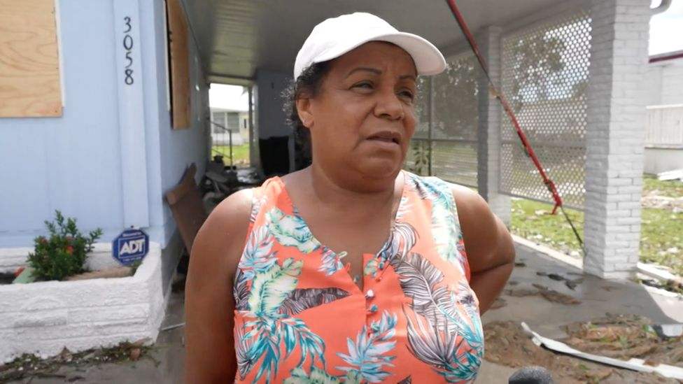 Diole Ado outside her damaged home in Fort Myers