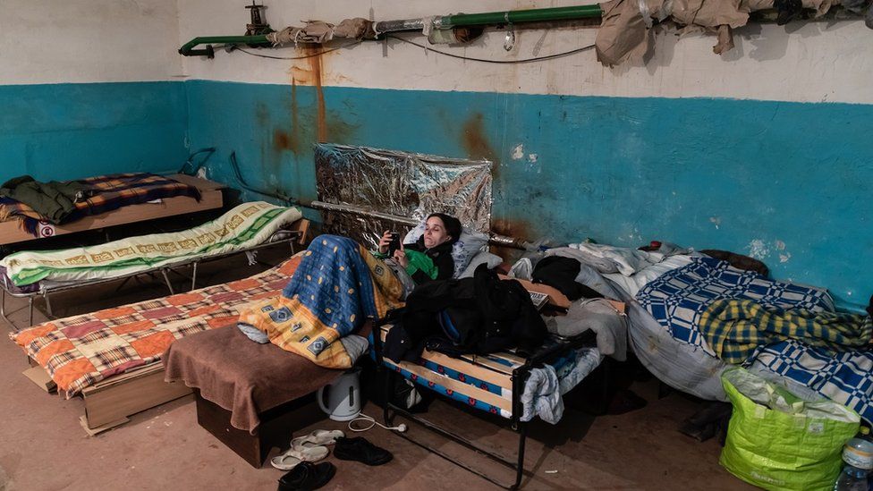 A woman in a bomb shelter in Kyiv