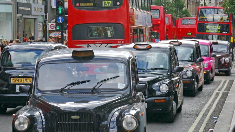 London Black Taxi Cabs and various Red Buses in Oxford Street,