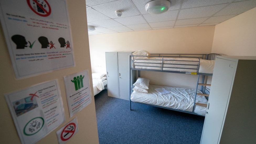 A bedroom at the airbase. It shows multiple beds including bunk beds in one room