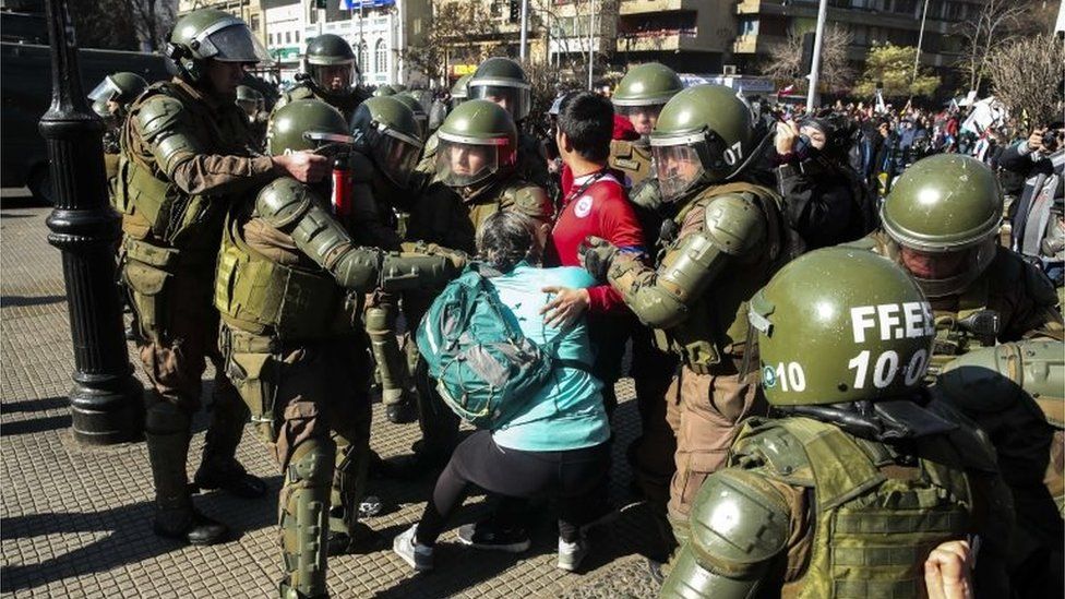 Police officers arrest a protester during a demonstration against the Chilean Government's education policies, in Santiago, Chile, 03 July 2019, after five weeks of strike of education professionals