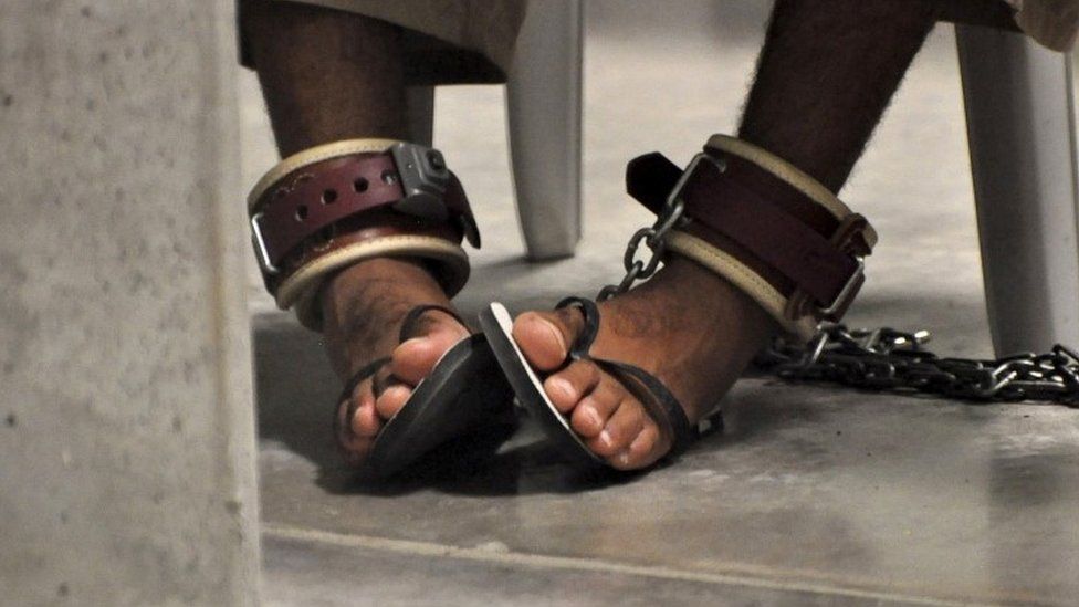 Guantanamo detainee's feet shackled to the floor