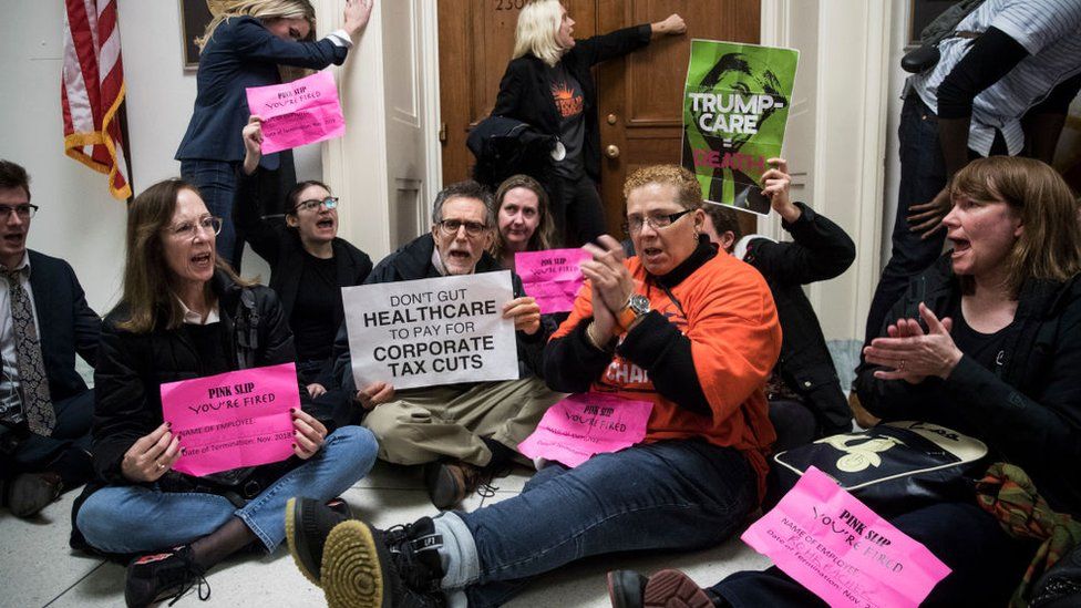 Protesters sat in the halls of Congress to oppose the tax cuts earlier this month