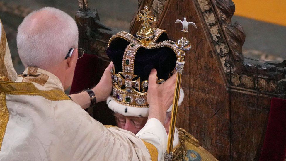 King Charles with the crown being placed on his head