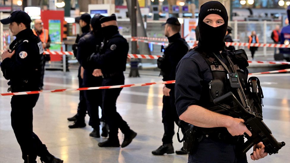 French police officers stand in the train station Gare du Nord after securing the scene of a knife attack, in Paris, France, 11 January 2023