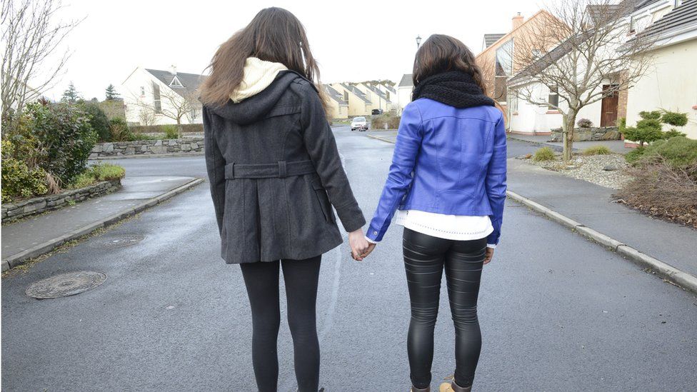 teenage girls holding hands