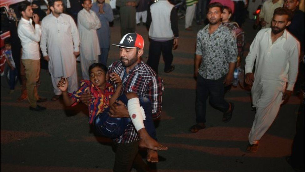 An injured boy is carried to hospital in Lahore